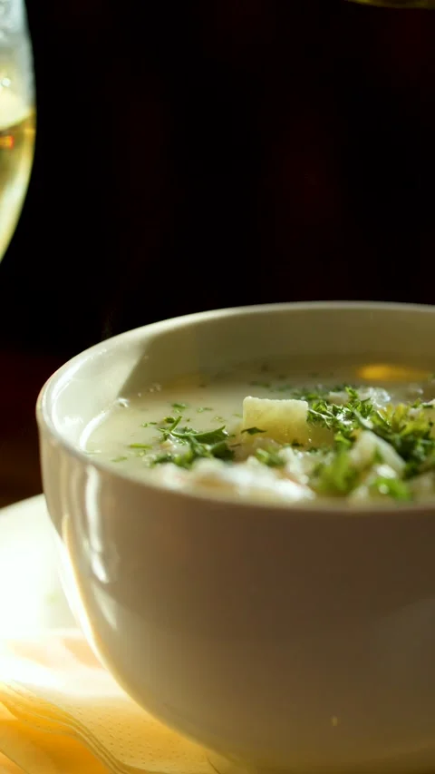 Creamy Chowder and White Wine in Warm Restaurant Light Stock Footage 318504685