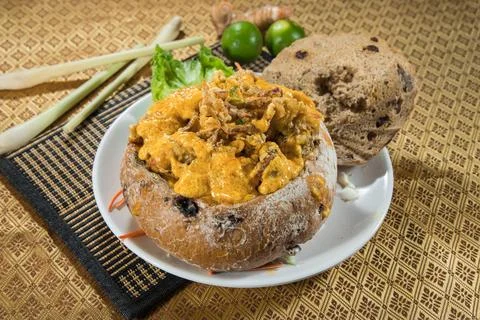 Creamy curry served in rustic bread bowl 写真素材