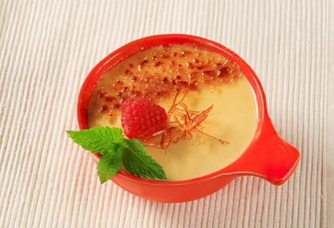 Creamy dessert with raspberry and mint garnish Stock Photos