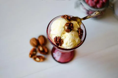 Creamy ice cream with honey and walnuts. Served in a bowl with ice cream, gar Stock Photos
