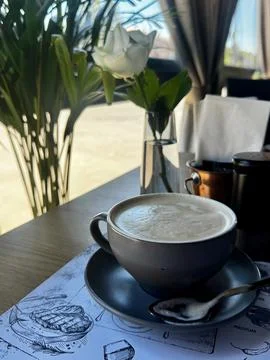 Creamy Latte in Rustic Ceramic Mug on Café Table Stock Photos