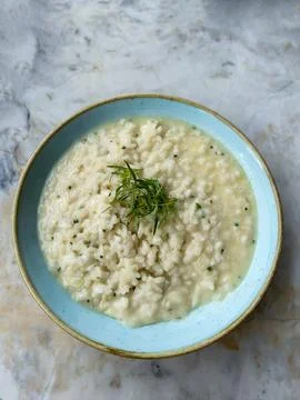 Creamy Lemon Risotto in a Blue Ceramic Bowl 写真素材