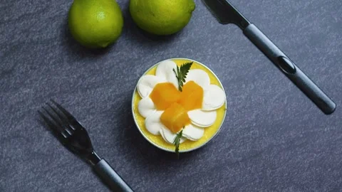 Creamy mango mousse cake Tin Can garnished with whipped cream, fresh mango Stock Footage 313291880