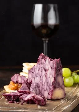 Creamy port wine derby cheese on wooden board with grapes and chutney Stock Photos