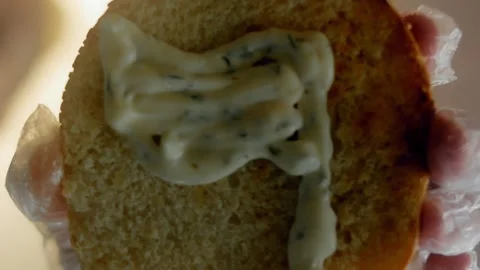 Creamy sauce pattern covering the inside of a sesame bun, 4K 库存影片 341120072