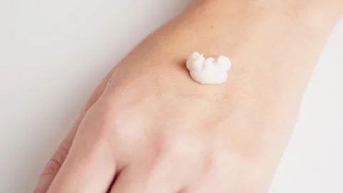 Creamy scrub falling at the woman's hand. Cosmetology, hand care, spa cosme.. Stock Footage 257465668