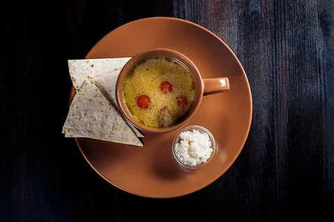 Creamy soup with pita bread in a plate, beautiful serving, dark background Stock Photos