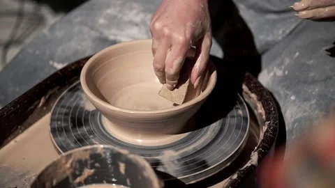 Create of ceramic bowl on a turntable. Young lady in pottery workshop Stock Footage 201568570