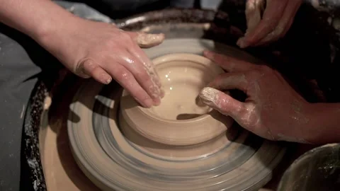 Create of ceramic bowl by young lady hands with help of teacher Stock Footage 201568492