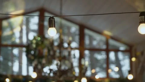 Create cozy indoor ambiance with string lights and decorations for festive vibe Stock Footage 314575585