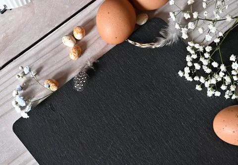 Create an Easter composition of Easter quail eggs and flowers on a white wo.. Stock Photos