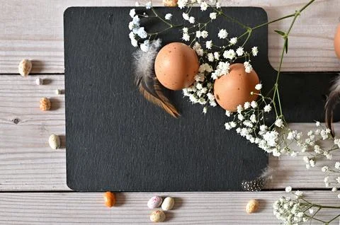 Create an Easter composition of Easter quail eggs and flowers on a white wo.. Stock Photos