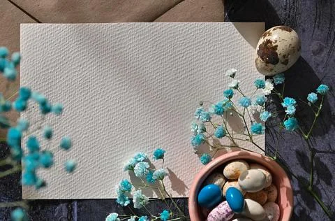 Create an Easter composition of Easter quail eggs and flowers on a white wo.. Stock Photos