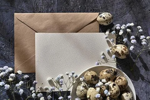Create an Easter composition of Easter quail eggs and flowers on a white wo.. Stock Photos