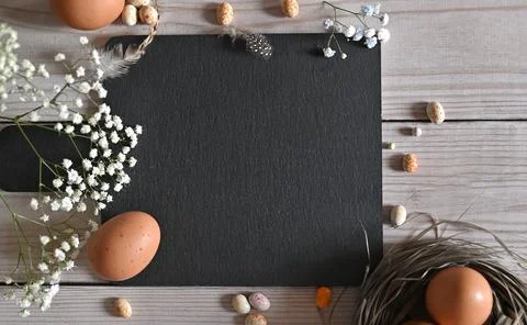 Create an Easter composition of Easter quail eggs and flowers on a white wo.. Stock Photos