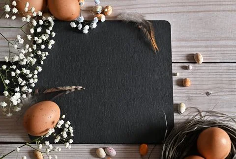 Create an Easter composition of Easter quail eggs and flowers on a white wo.. Stock Photos