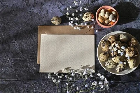 Create an Easter composition of Easter quail eggs and flowers on a white wo.. Stock Photos