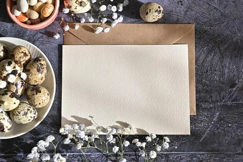 Create an Easter composition of Easter quail eggs and flowers on a white wo.. Stock Photos