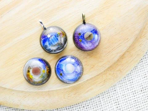 Create galaxy drink coasters using resin, glitter and pigment powders, handma Stock Photos