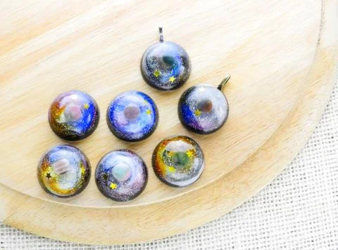 Create galaxy drink coasters using resin, glitter and pigment powders, handma Stock Photos