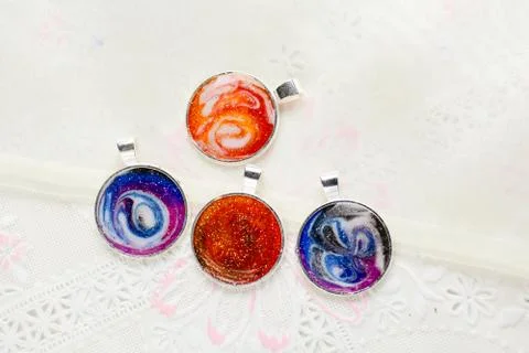 Create galaxy drink coasters using resin, glitter and pigment powders, handma Stock Photos