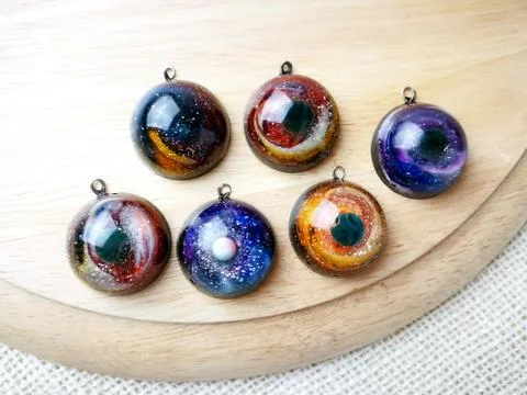 Create galaxy drink coasters using resin, glitter and pigment powders, handma Stock Photos