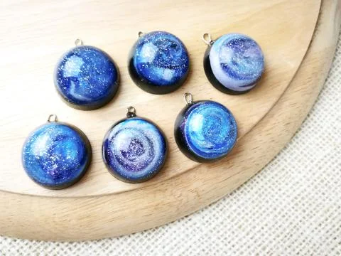 Create galaxy drink coasters using resin, glitter and pigment powders, handma Stock Photos
