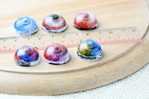 Create galaxy drink coasters using resin, glitter and pigment powders, handma Stock Photos