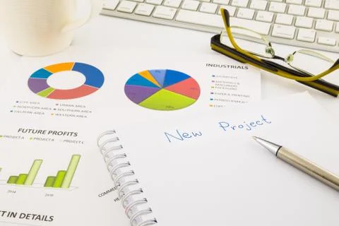 Create ideas for new project, graph and chart with blank paper on office tabl Stock Photos