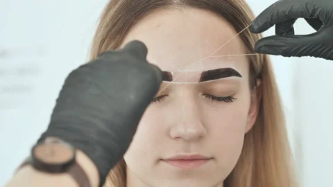 Create permanent eyebrow makeup. Create permanent eyebrow makeup. Thread peeling Stock Footage 115841799