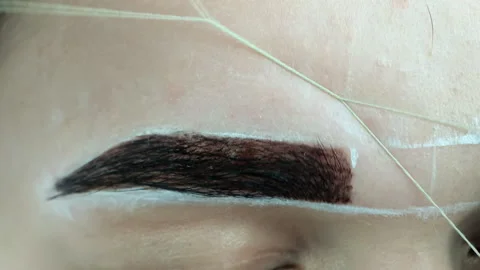 Create permanent eyebrow makeup. Create permanent eyebrow makeup. Thread peeling Stock Footage 115886057
