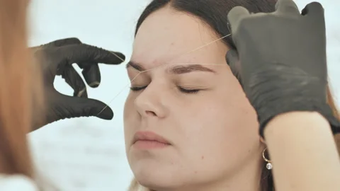 Create permanent eyebrow makeup. Create permanent eyebrow makeup. Thread Stock Footage 121326920