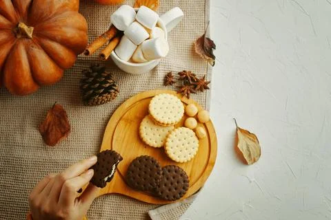 Create a warm autumn atmosphere by arranging biscuits and marshmallows on a Stock Photos