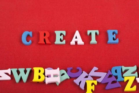 CREATE word on red background composed from colorful abc alphabet block woo.. Foto stock