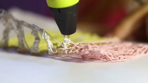 Creating a 3D object with a pen close-up. Modern hobby, Stock Footage 159704968