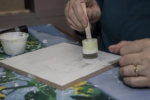 Creating art with texture on a blank canvas during a crafting session in a .. Stock Photos