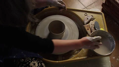 Creating beautiful ceramic pottery with hands on a wheel Stock Footage 321543057