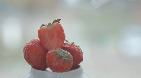 Creating a bed of sweet white whipped cream for a red ripe strawberry Stock Footage 68955328