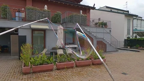 Creating big soap bubbles with sticks and rope, slow-motion Video stock 279424202