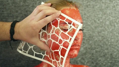 Creating body art with the help of a stencil slow motion Stock Footage 74350436
