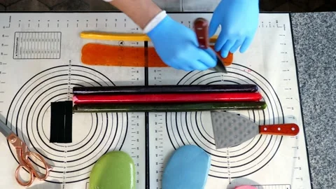 Creating candies with a pattern inside of elastic caramel of different colors. Stock Footage 233716923