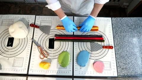 Creating candies with a pattern inside of elastic caramel of different colors. Stock Footage 233897063
