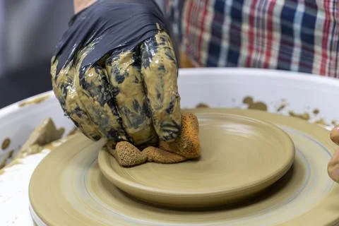Creating a ceramic bowl in a pottery class. Wheel throwing. Learning how to.. Stock Photos
