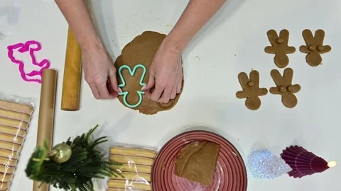 Creating cheeky gingerbread men in a festive kitchen setting Video stock 344820890