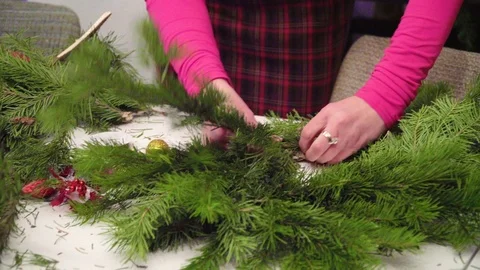 Creating a Christmas wreath with decorations. Close-up Stock Footage 70964103