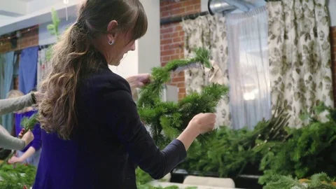Creating a Christmas wreath with decorations. Close-up Video stock 70965325