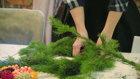 Creating a Christmas wreath with decorations. Close-up Stock Footage 70966073