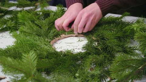 Creating a Christmas wreath with decorations. Close-up Stock Footage 70968675