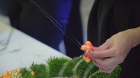 Creating a Christmas wreath with decorations. Close-up Video stock 70969251