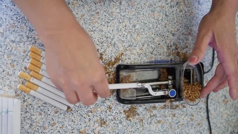 Creating Cigarettes with the Use of a Tobacco Rolling Machine Stock Footage 282588523